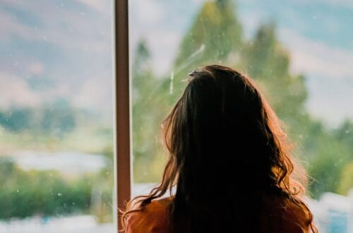 woman wearing brown shirt inside room